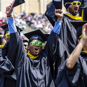 FILE - In this May 19, 2019, file photo, Prathik Kotian of Sunnyvale, CA, center, cheers with the School of Computer Science 2019 graduating class as they are recognized at the end of the Carnegie Mellon University 2019 Commencement ceremony in Gesling Stadium at Carnegie Mellon University in Oakland. Leslie Odom Jr., Tony and Grammy award-winning performer and CMU alumni, was awarded an honorary Doctor of Fine Arts degree and spoke as the keynote speaker during the ceremony. (Jessie Wardarski/Post-Gazette)