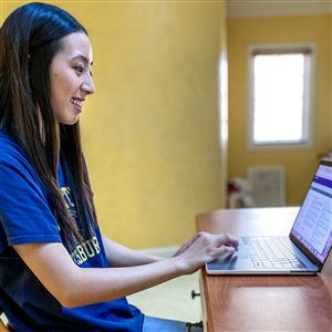 Cassandra Hom is pictured in an undated photo accessing class materials via Courseweb. Ms. Hom is currently staying with extended family in Ohio while university campuses are closed. 