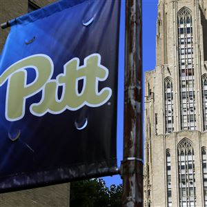In this file photo, the Cathedral of Learning, right, towers over the University of Pittsburgh campus in Oakland on July 8, 2019.