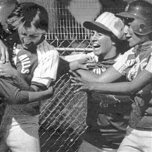 Janet Bowker, far left, of North Hills High School is greeted at home plate by Melanie Lees (left), Linda Massucci and Sue Spragale, after Bowker scored the winning run in the top of the seventh inning of the 1980 PIAA Class 3A championship game against North Penn. 