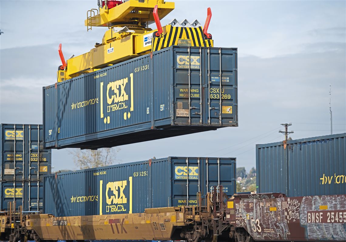 A container is stacked on top of another one as rail freight is prepared for transportation Thursday, Nov. 2, 2017, at the  CSX Intermodal Terminal in McKees Rocks. 