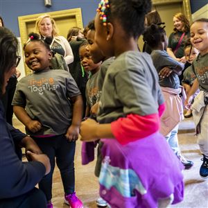 Lindsey Ramsey, a public policy regional coordinator for Trying Together, dances with students from One Small World Early Learning in 2019. Ms. Ramsey, of Arlington, and the others were attending a City Council meeting that declared Sept. 24 
