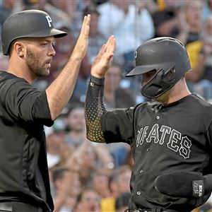 Jacob Stallings congratulates Kevin Newman after scoring against the Reds last August at PNC Park.