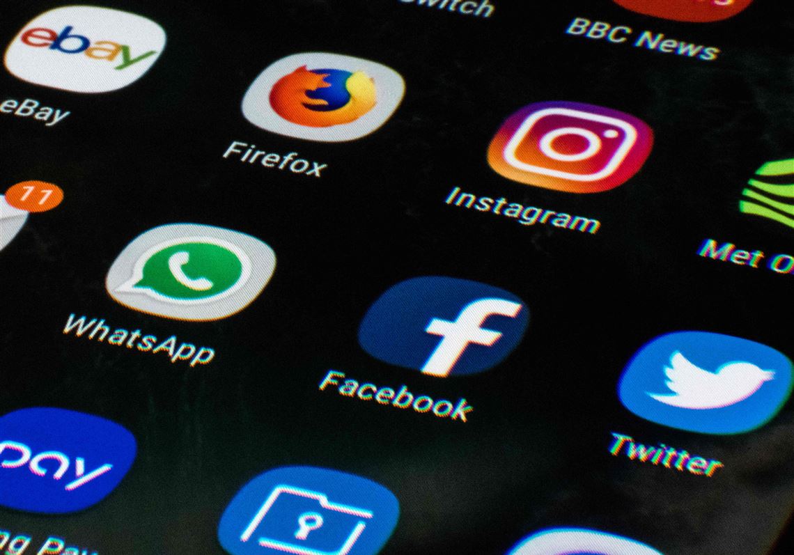 A mobile phone screen displays the icons for the social networking apps Facebook, Twitter and Instagram, taken in Manchester, England on March 22, 2018.