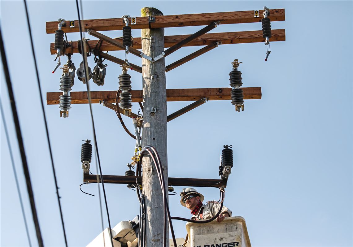 Mike Joyce, a journeyman underground splicer with Duquesne Light, works on a utility poll on Friday, May 15, 2020, in Oakland. 