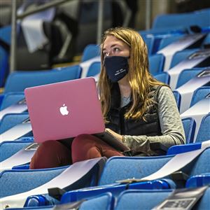 A student attends class in the 16,000-seat Bryce Jordan Center at Penn State University on Thursday, Oct. 8, 2020 in State College. Thousands of dorm students are getting price reductions equal to about 16% of standard room and board bills for the spring semester, given the school’s decision to push back in-person classes by four weeks to Feb. 15.