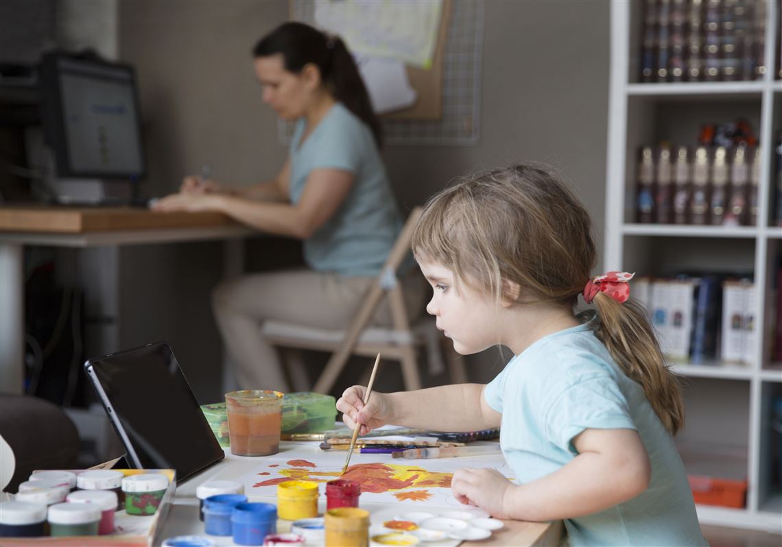 File image of a mother working from home with her daughter during the quarantine.