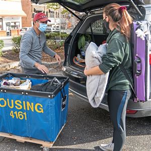 In this file photo, Jan Zhang, of Buffalo, N.Y., helps his daughter Lilliana — a freshman at the University of Pittsburgh — move out of her dorm for Thanksgiving break Nov. 19, 2020 in Oakland.   Pitt on Wednesday, Jan. 13, 2021, advised all students heading for spring semester to the school’s main and regional campuses, and surrounding neighborhoods, that they can arrive starting Jan. 29.
