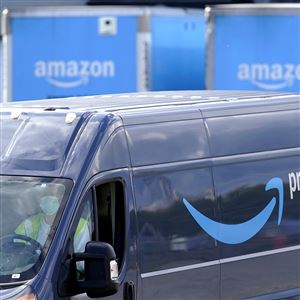 An Amazon Prime logo appears on the side of a delivery van as it departs an Amazon Warehouse location, Thursday, Oct. 1, 2020, in Dedham, Mass. 