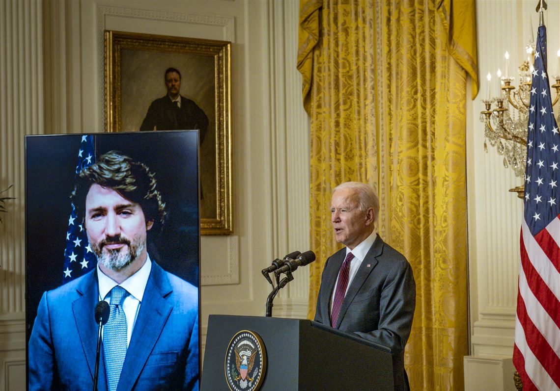 President Joe Biden, right, and Canadian Prime Minister Justin Trudeau deliver opening statements via video link on Tuesday in the East Room of the White House in Washington.