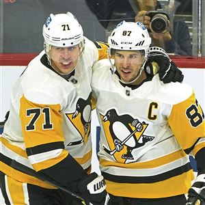 Pittsburgh Penguins center Evgeni Malkin congratulates center Sidney Crosby after scoring goal against the Flyers Wednesday, Jan. 13, 2021, at the Wells Fargo Center in Philadelphia.   