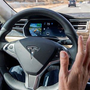A member of the media test-drives a Tesla Model S car equipped with self-driving functions in Palo Alto, Calif., on Oct. 14, 2015.