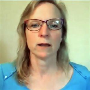 Vivian Severn, the wife of a professor who will lose his job Friday, gives an emotional speech on behalf of her husband during a public hearing Thursday night about the campus mergers across the State System of Higher Education. 