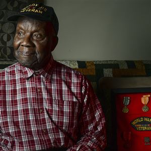 World War II veteran Henry Parham sits inside his Wilkinsburg home in 2018.