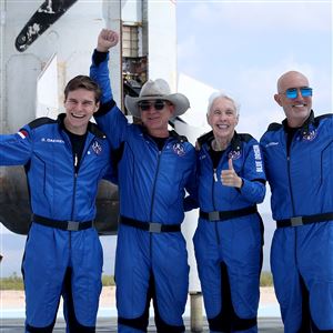Blue Origin's New Shepard crew, left to right, Oliver Daemen, Jeff Bezos, Wally Funk, and Mark Bezos pose for a picture near the booster after flying into space in the Blue Origin New Shepard rocket on July 20, 2021 in Van Horn, Texas. Mr. Bezos and the crew were the first human spaceflight for the company.