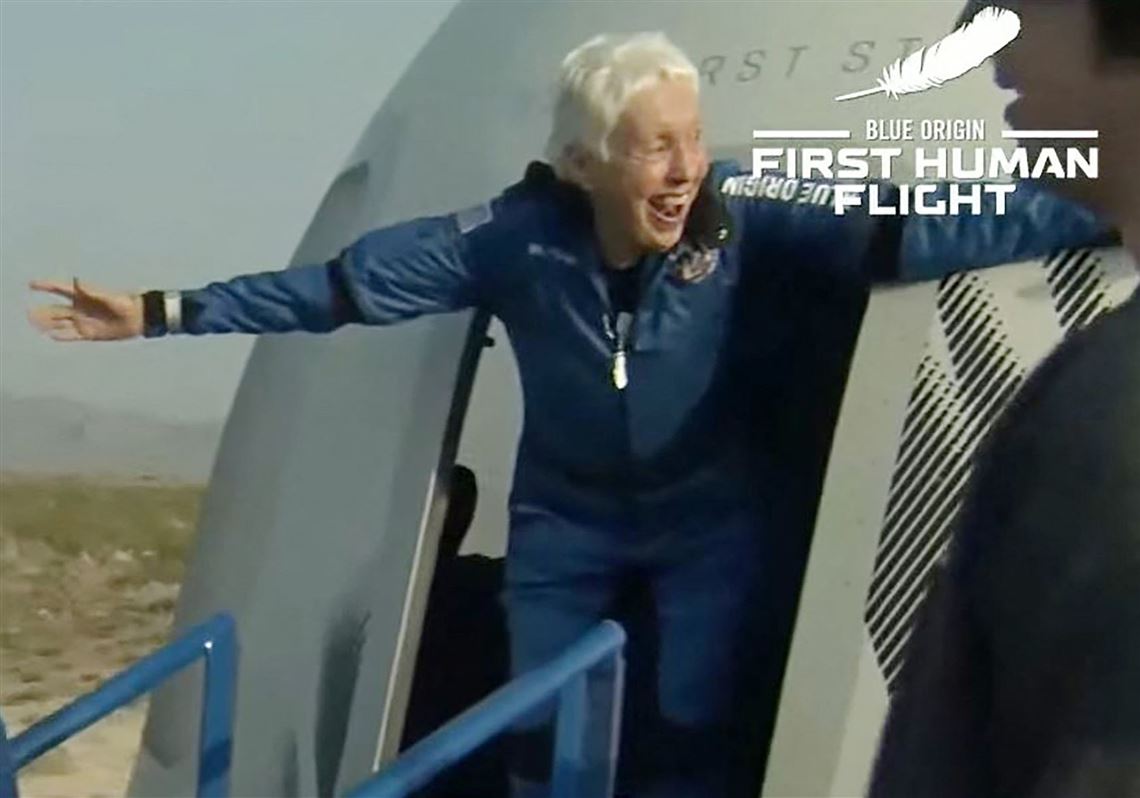 This still image taken from video by Blue Origin shows Wally Funk, right, exiting Blue Origin's New Shepard capsule after it returned from space and landed safely on July 20, 2021, near Van Horn, Texas.