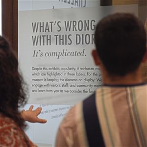 LouAnn Shrecengost of Worthington, Pa., reads the label that explains the historical and racial issues with the 