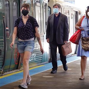 Commuters wearing face masks arrive in the Loop on an L train on July 27, 2021 in Chicago, Illinois. 