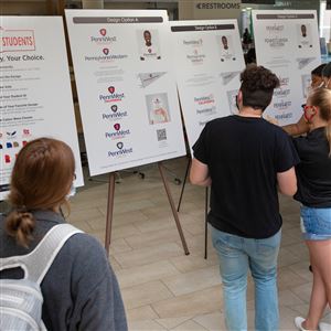 Students at Cal U look over the design options for the name of the new integrated university, Pennsylvania Western University, that will be launched this fall.   