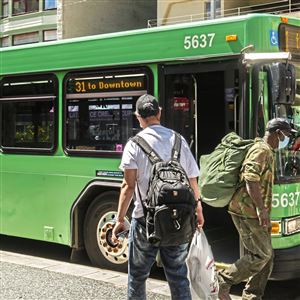 Masked passengers board a Port Authority bus near Market Square on Wednesday, June 23, 2021.