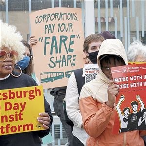 Members of Pittsburghers for Public Transit hold a press conference to release the 100 Days Transit Platform, Thursday, Dec. 16, 2021, in Oakland. 