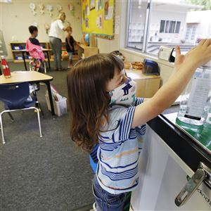 Jackson Middleton, a kindergarten student, uses hand sanitizer in his classroom at Chadwick School in Palos Verdes, Calif.
