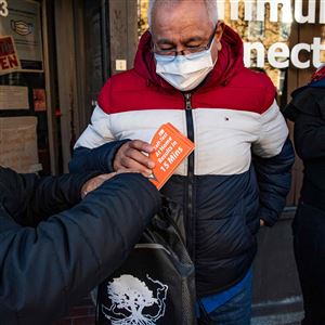 Rapid at-home Covid-19 test kits are handed out to people at Chelsea Community Connections in Chelsea, Massachusetts, on December 17, 2021. - 
