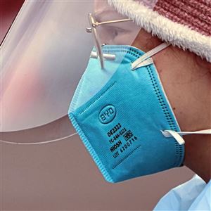 A medical assistant wears an N95 mask at a testing clinic.