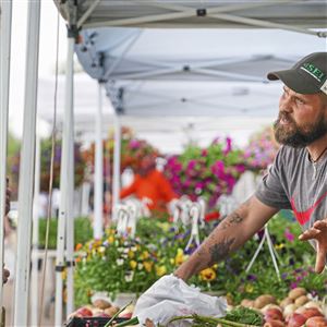 Fourth-generation farmer Joe Jodikinos discusses the vegetables available at his family’s booth at the Bethel Park Farmers Market at South Park.