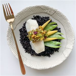 Steamed cod is served atop black rice with snow peas, ginger and scallions.