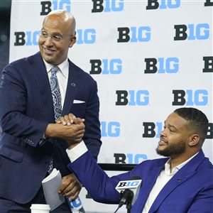 Penn State head coach James Franklin talks with defensive tackle PJ Mustipher during an NCAA college football news conference at the Big Ten Conference media days, at Lucas Oil Stadium, Wednesday, July 27, 2022, in Indianapolis. 
