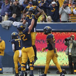 West Virginia offensive lineman Doug Nester (72) and wide receiver Bryce Ford-Wheaton (0) celebrate after a touchdown during the second half of an NCAA college football game against Iowa State in Morgantown, W.Va., Saturday, Oct. 30, 2021. 