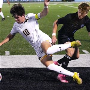 North Allegheny’s Ben Christian falls as he and Seneca Valley’s Will Bruno battle for the ball during Tuesday's match at Seneca Valley. The host Raiders prevailed, 3-2, in overtime.
