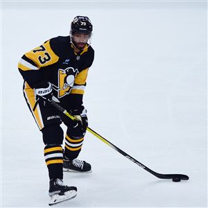 Penguins defenseman Pierre-Olivier Joseph waits to pass the puck during Pittsburgh’s loss to the Chicago Blackhawks in the season opener at PPG Paints Arena on Tuesday, Oct. 10, 2023. 