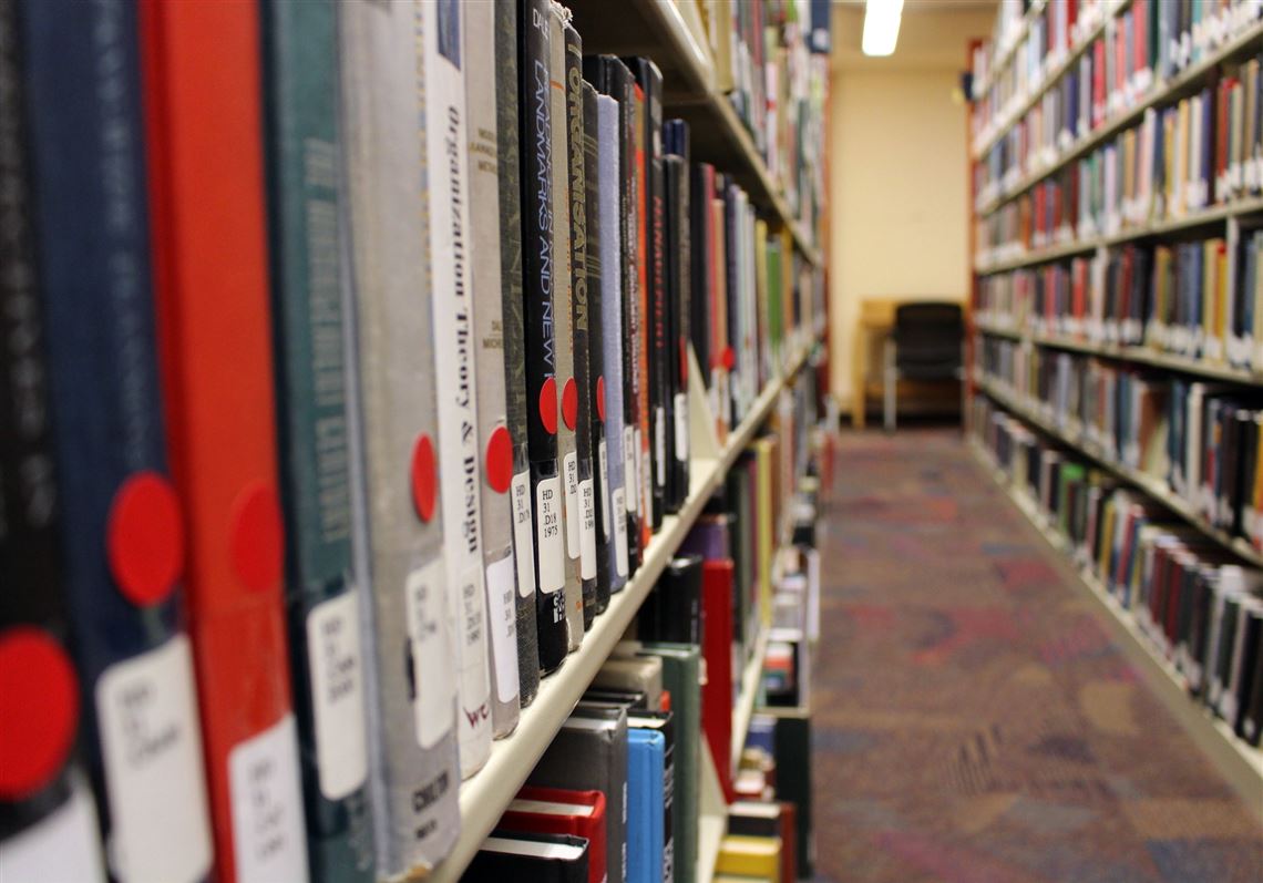 In this Jan. 25, 2018, photo, books marked with red stickers, meaning they might be removed from the shelves, are on display at the Indiana University of Pennsylvania library in Indiana, Pa. 