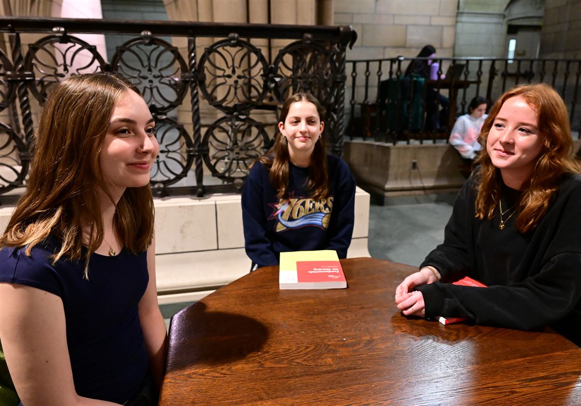 University of Pittsburgh students, from left, Sydney Greenway, Clara Gilles and Julia Trachtman meet at the Cathedral of Learning on Wednesday, Jan. 24, 2024 to talk about ways to get cheaper textbooks.   