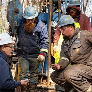 Steve Plants, former CEO of Plants & Goodwin, a well-plugging company based in Bradford, talks with rig operator Brendan Green, right, and workers Billy Carr, center, and Corry Copp, back right, at a site where an orphan well was being plugged in Leeper, Clarion County, on Monday, Nov. 6, 2023. 