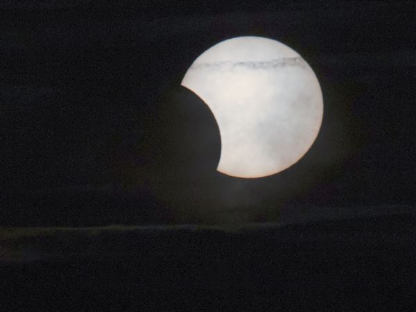A partial solar eclipse photographed over Downtown Pittsburgh on Wednesday, June 9, 2021. Ahead of this year's solar eclipse on April 8, some Pittsburgh-area school districts have canceled classes because of safety concerns for students being dismissed during the eclipse.   
