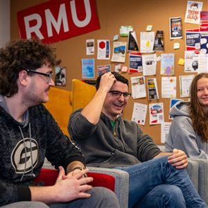 Robert Morris University seniors, from left, Alex Morrison, Cade Skuse and Megan Ledgerwood, discuss on March 20, 2024 a senior prom they will have on campus to make up for not having a high school prom due to COVID-19.