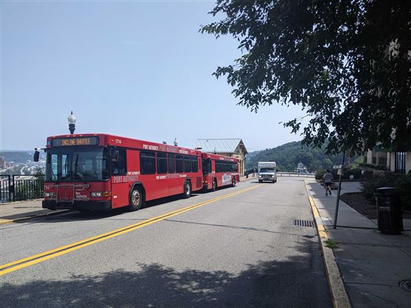 Pittsburgh Regional Transit shuttle buses sit near the Mon Incline in 2023. 
