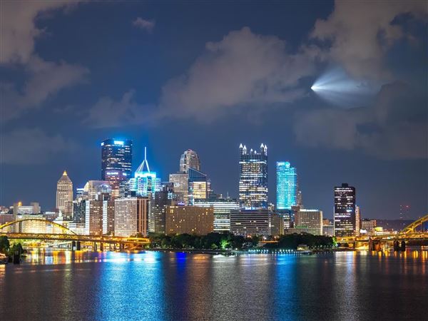 The Polaris Dawn capsule carrying four SpaceX astronauts is seen over the Pittsburgh skyline on Sept. 10, 2024 as it rockets into orbit seven minutes after a launch from Florida. Dustin McGrew, a photographer and lifelong space enthusiast, woke up in the middle of the night to capture the surprising image, which he said demonstrates in a single frame the city’s close connection to space endeavors.