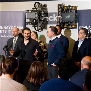 Gov. Josh Shapiro speaks with Jake Loosararian, co-founder and CEO of Gecko Robotics, at the startup's North Shore headquarters on Thursday, March 21. Mr. Shapiro visited the wall-scaling robot builder as part of his bid for state funding for robotics and tech, one pillar of his 10-year economic development plan. 