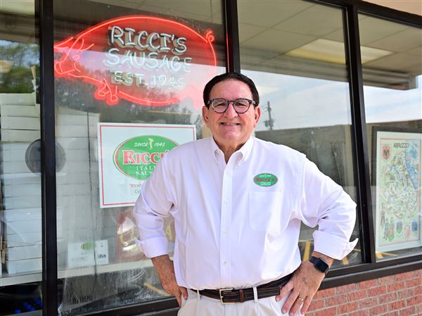 Third-generation owner Ernie Ricci stands in front of his family store, Ricci’s Italian Sausage.
