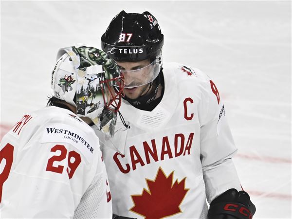 Canada's Sidney Crosby and Marc-Andre Fleury celebrating after winning the IIHF Ice Hockey World Championship group A match between Latvia and Canada at Avicii Arena in Stockholm, Sweden, Sunday, May 11, 2025. 