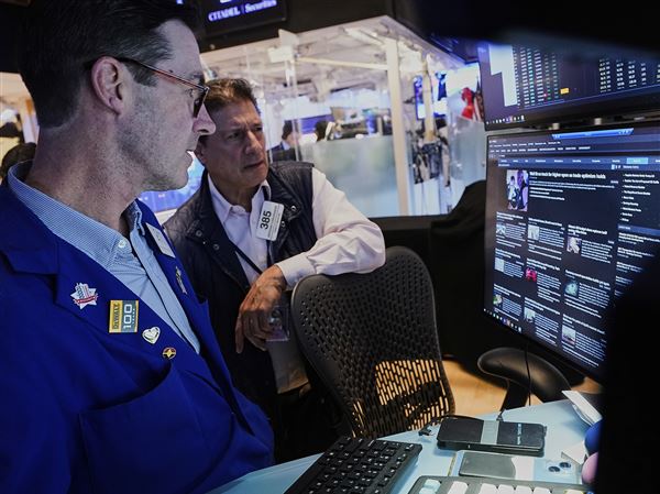 Specialist John McNierney, left, and trader Anthony Carannante work on the floor of the New York Stock Exchange, Wednesday, May 14, 2025. 