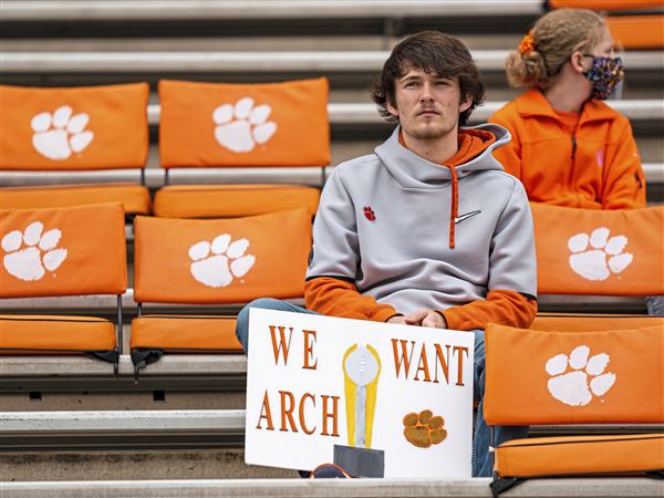 A fan holds a sign referencing high school recruit Arch Manning before the game between the Clemson Tigers and the Florida State Seminoles at Clemson Memorial Stadium on October 30, 2021 in Clemson, South Carolina.