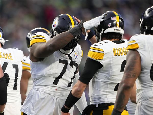 Pittsburgh Steelers offensive tackle Broderick Jones greets quarterback Mason Rudolph (2) during the second half of an NFL football game against the Seattle Seahawks, Sunday, Dec. 31, 2023, in Seattle. The Steelers won 30-23.