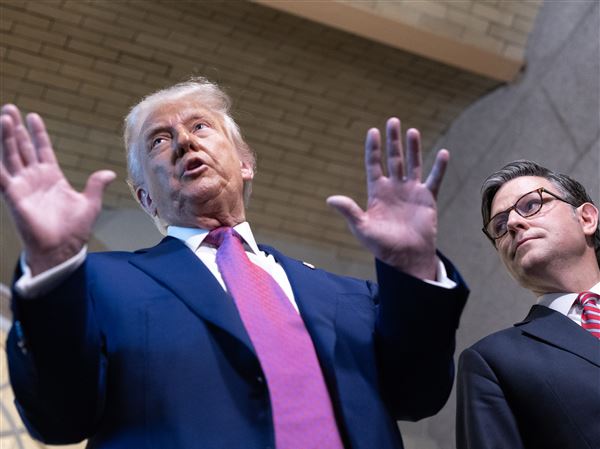 President Donald Trump and House Speaker Mike Johnson (R-Louisiana) speak to reporters after a closed-door meeting with House Republicans on Tuesday. MUST CREDIT: Tom Brenner/For The Washington Post