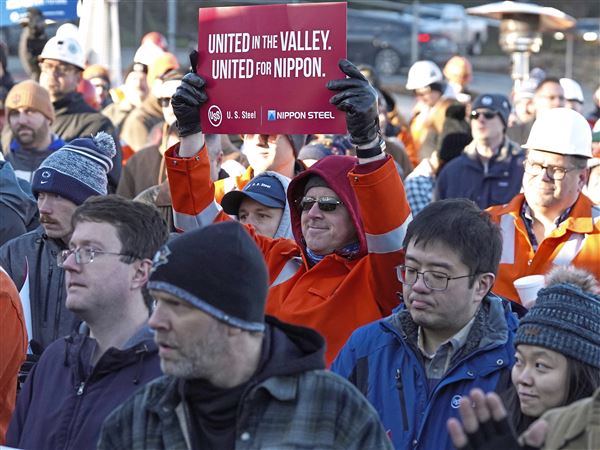 A U.S. Steel worker holds up a sign at a rally in support of the company’s proposed $15 billion sale to Nippon Steel, outside of the Clairton Mill Works in Clairton Thursday, Dec. 12, 2024.  
