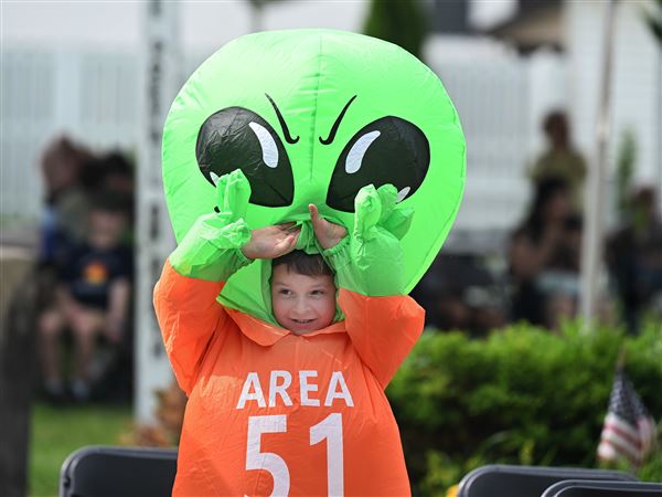 Gabe Walowen fixes his alien head to get ready for the Costume contest during the Mars New Years Festival in Mars on Saturday June 7, 2025. 